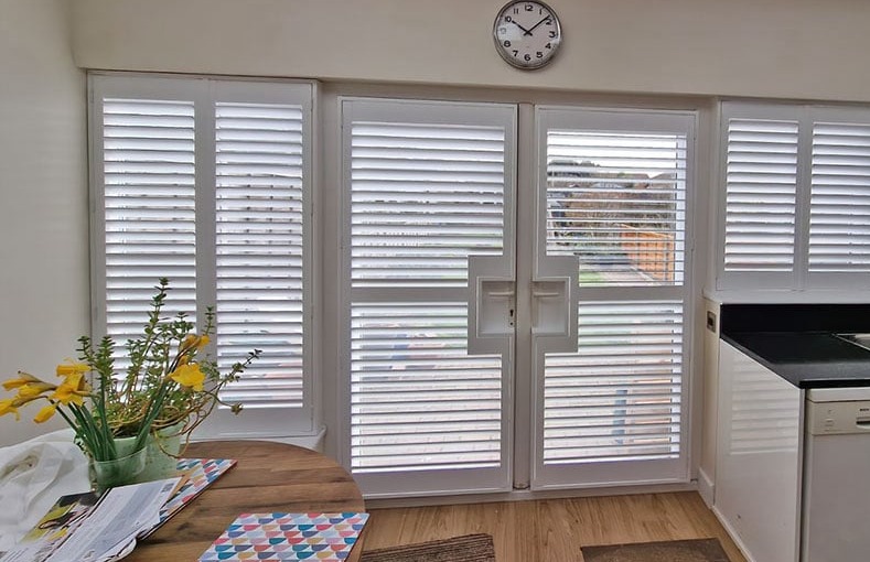 French cut shutters installed on full height opening doors in a kitchen