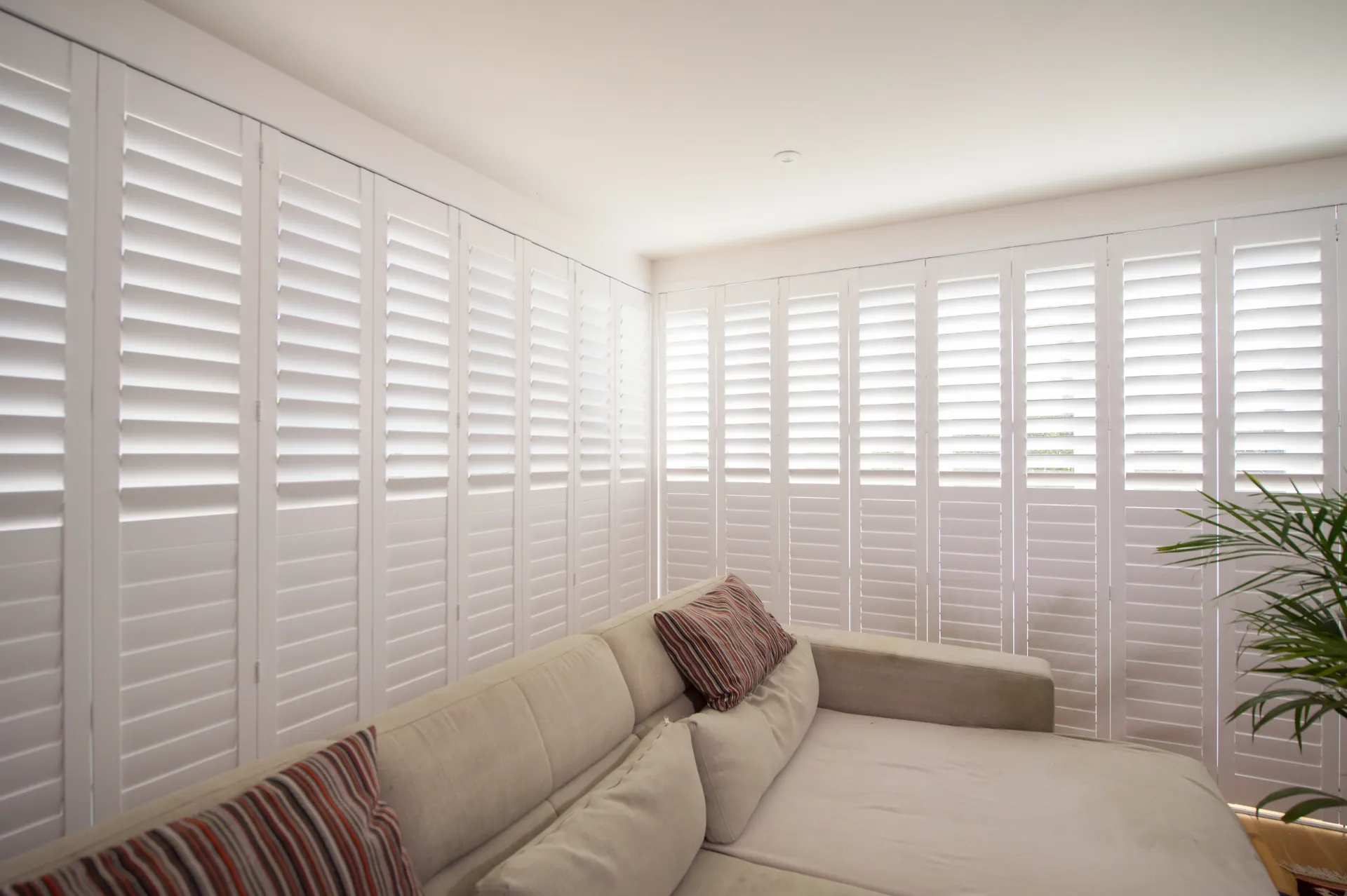 Tracked plantation shutters Hampshire full wall — dramatic architectural fitted shutters